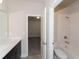 Bathroom with vanity and combination tub and shower with white tiled walls at 951 Olmsted Ln, Johns Creek, GA 30097