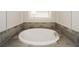 Relaxing bathroom showcasing a large soaking tub with nice tile work and a modern faucet at 951 Olmsted Ln, Johns Creek, GA 30097