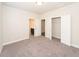 Bright bedroom featuring neutral carpet, white walls, closet, and ensuite bathroom at 951 Olmsted Ln, Johns Creek, GA 30097