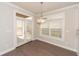 Bright breakfast nook with French doors, hardwood floors, and pendant lighting at 951 Olmsted Ln, Johns Creek, GA 30097