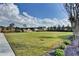 Vast, open community lawn under a bright, cloudy sky, perfect for recreation and relaxation at 951 Olmsted Ln, Johns Creek, GA 30097