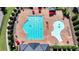 Aerial view of a pristine community pool with clear blue water, surrounded by seating and landscaping at 951 Olmsted Ln, Johns Creek, GA 30097