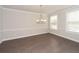 Spacious dining room with hardwood floors, elegant chandelier and bright windows at 951 Olmsted Ln, Johns Creek, GA 30097