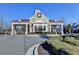 Stone community entrance featuring manicured landscaping and a gated entry at 951 Olmsted Ln, Johns Creek, GA 30097
