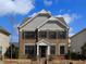 Charming two-story brick home with gray siding and well-maintained landscaping at 951 Olmsted Ln, Johns Creek, GA 30097