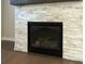 Close-up of a modern gas fireplace with stone surround and dark mantel at 951 Olmsted Ln, Johns Creek, GA 30097