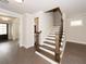 Inviting foyer featuring hardwood floors and an open staircase leading to the upper level at 951 Olmsted Ln, Johns Creek, GA 30097