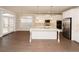 Open-concept kitchen with stainless appliances, kitchen island, and access to the backyard at 951 Olmsted Ln, Johns Creek, GA 30097