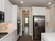 Modern kitchen with stainless steel appliances, including double ovens, and white cabinets at 951 Olmsted Ln, Johns Creek, GA 30097