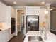 Modern kitchen with stainless steel appliances, including double ovens, and white cabinets at 951 Olmsted Ln, Johns Creek, GA 30097