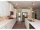 Bright kitchen with stainless steel appliances, kitchen island, and white cabinets at 951 Olmsted Ln, Johns Creek, GA 30097