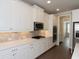 Well-appointed kitchen features white cabinets, stainless steel appliances, and tile backsplash at 951 Olmsted Ln, Johns Creek, GA 30097