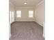 Cozy living room featuring plush carpet and ample natural light at 951 Olmsted Ln, Johns Creek, GA 30097