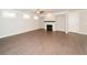 Open-concept living room with a fireplace, hardwood floors, and recessed lighting at 951 Olmsted Ln, Johns Creek, GA 30097