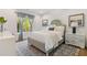 Cozy bedroom featuring a stylish bed, patterned rug, bedside table, and bright window at 1002 Citadel Ne Dr, Atlanta, GA 30324