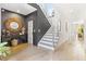 Bright foyer with wood floors, a modern staircase, and elegant decorative details at 1002 Citadel Ne Dr, Atlanta, GA 30324