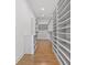 Spacious walk-in closet with wood flooring, custom shelving, and ample storage space at 1002 Citadel Ne Dr, Atlanta, GA 30324