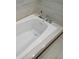 Close-up of a bath tub featuring sleek fixtures and light tile flooring at 233 Burbank Nw Dr, Atlanta, GA 30314