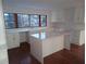 Bright kitchen features white cabinets, stainless steel appliances, an island, and a window over the sink at 233 Burbank Nw Dr, Atlanta, GA 30314