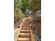 Exterior stairway crafted with wood creating a natural and accessible path through the yard at 8210 Sentinae Chase Dr, Roswell, GA 30076