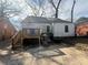 Back exterior with wood deck, stone foundation, and level backyard at 939 Hope Sw Dr, Atlanta, GA 30310