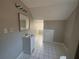Bathroom with sink, mirror, lighting and tile floors at 939 Hope Sw Dr, Atlanta, GA 30310