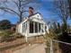 Side view of home, with a unique sunroom, stone foundation and private driveway at 939 Hope Sw Dr, Atlanta, GA 30310