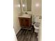 Compact bathroom with vinyl flooring, single sink vanity, and standard toilet at 3636 Hopkins Ct, Powder Springs, GA 30127