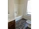 Bathroom featuring a tub shower, vanity with drawers, vinyl flooring, and a window at 3636 Hopkins Ct, Powder Springs, GA 30127