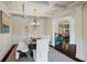 Elegant dining room featuring a coffered ceiling, wainscoting detail, and view to the living room at 4410 Silent Path, Cumming, GA 30028