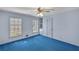 Bright bedroom features built-in shelving, blue carpet, and light-blue painted walls at 6185 Heards Creek Dr, Atlanta, GA 30328