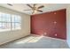 Carpeted bedroom with a ceiling fan and natural light from the window at 7592 Didwell Ct, Jonesboro, GA 30236