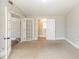 Bedroom with carpeted floor and french doors leading to staircase and a bathroom at 940 Blair Bridge Rd, Austell, GA 30168
