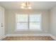 Bright dining room with a classic chandelier and window views at 940 Blair Bridge Rd, Austell, GA 30168