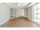 Open living room with hardwood floors, large windows, and decorative columns at 940 Blair Bridge Rd, Austell, GA 30168