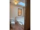Bathroom features a toilet, tub, and mosaic tile accents at 1531 Glendale Dr, Lawrenceville, GA 30043