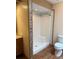 White bathroom with a shower, toilet, and mosaic tile accents at 1531 Glendale Dr, Lawrenceville, GA 30043