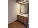 Bathroom features a double sink vanity with wooden cabinets and a large mirror at 1531 Glendale Dr, Lawrenceville, GA 30043