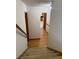 Hallway with hardwood flooring leading to stairs and featuring a full view into the kitchen at 1531 Glendale Dr, Lawrenceville, GA 30043