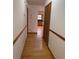 Hallway featuring wood floors and trimmed woodwork that leads to the kitchen area at 1531 Glendale Dr, Lawrenceville, GA 30043