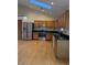 Well-lit kitchen featuring stainless steel appliances, wood cabinets, and granite counter tops at 1531 Glendale Dr, Lawrenceville, GA 30043