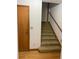 Carpeted stairs lead to the upper level from a hallway with a closet and hardwood floors at 1531 Glendale Dr, Lawrenceville, GA 30043