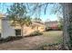 Backyard with brick home, large lawn, and mature trees at 2236 Chestnut Hill Cir, Decatur, GA 30032