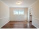 Cozy dining room with wood floors, chair rail, and a large window overlooking the yard at 2236 Chestnut Hill Cir, Decatur, GA 30032