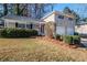 Beautifully landscaped front yard with a charming brick facade and inviting red front door at 2236 Chestnut Hill Cir, Decatur, GA 30032
