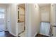 Hallway featuring full bathroom, stairs to basement and 2 doorways at 2236 Chestnut Hill Cir, Decatur, GA 30032