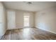 Bedroom featuring neutral tones, a white door, and wood-look flooring at 473 Oakside Sw Dr, Atlanta, GA 30331