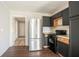 Kitchen featuring stainless steel appliances, black cabinetry, and modern floors at 473 Oakside Sw Dr, Atlanta, GA 30331