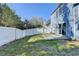 Lush backyard with concrete patio, enclosed by a pristine white fence at 1064 Wenham Ln, Lawrenceville, GA 30044