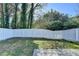 Manicured backyard with a well-maintained lawn and privacy fence at 1064 Wenham Ln, Lawrenceville, GA 30044
